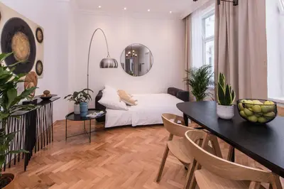 a living room with a bed and a table at New design APT - central location Wenceslas Square in Prague
