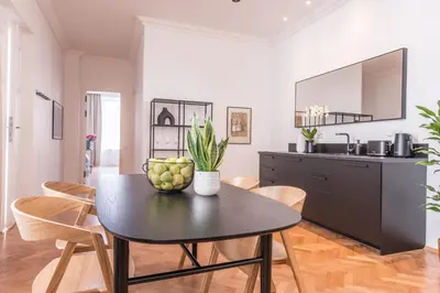 a kitchen and dining room with a table and chairs at New design APT - central location Wenceslas Square in Prague