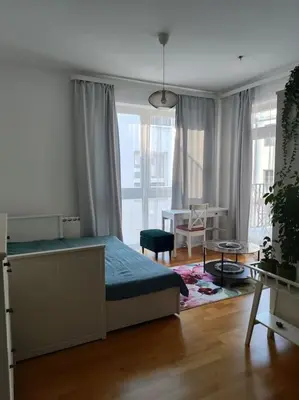 a bedroom with a bed and a table in it at Studio with balcony in Vinohrady in Prague
