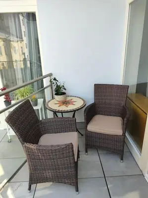 a balcony with two chairs and a table on a balcony at Studio with balcony in Vinohrady in Prague