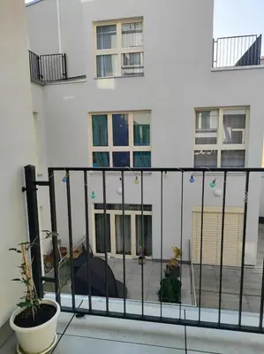 a balcony with a black fence and a building at Studio with balcony in Vinohrady in Prague