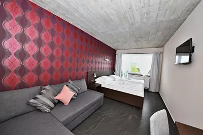 a living room with a couch and a bed at Pension Jezerná in Zduchovice
