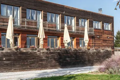 a building with umbrellas on a brick wall at Pension Jezerná in Zduchovice