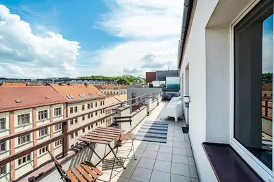 a balcony with chairs and a view of a city at 3 bedroom flat with amazing terrace in Prague
