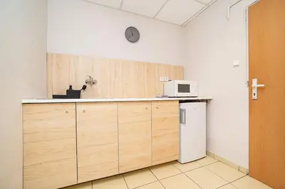 a kitchen with a counter with a microwave and a refrigerator at Bright 2 bed with big terrace by tram in Prague