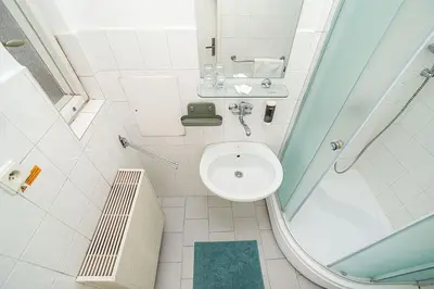 a small bathroom with a toilet and a sink at Bright 2 bed with big terrace by tram in Prague