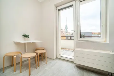 a room with two stools and a window at Bright 2 bed with big terrace by tram in Prague