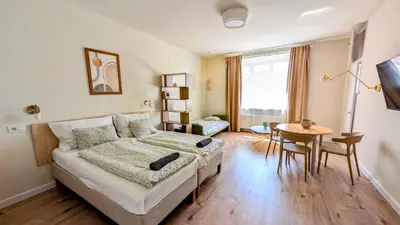 a bedroom with a bed and a desk and a table at Apartment in Zizkov -504- in Prague