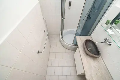 a bathroom with a sink and a shower and a toilet at Apartment in Zizkov -504- in Prague