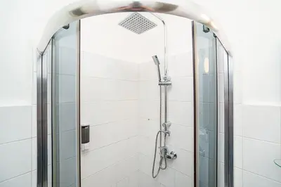 a shower with a glass door in a bathroom at Apartment in Zizkov -504- in Prague