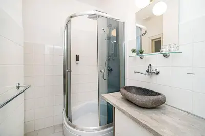 a bathroom with a sink and a shower at Apartment in Zizkov -504- in Prague