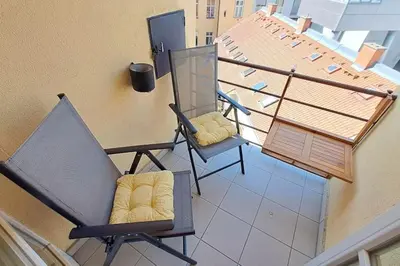 two chairs sitting on top of a balcony at Apartment in Zizkov -504- in Prague