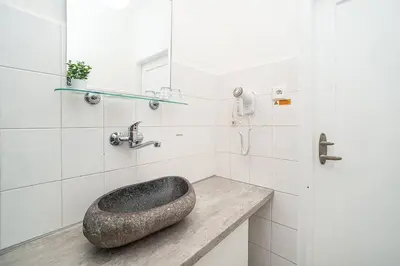a bathroom with a stone sink on a counter at Apartment in Zizkov -504- in Prague
