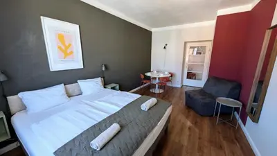 a bedroom with a large bed and a chair at Flat in Zizkov -502- in Prague