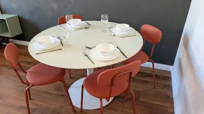 a white table with chairs and plates and wine glasses at Flat in Zizkov -502- in Prague