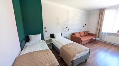 a hotel room with two beds and a couch at Flat in Zizkov -502- in Prague
