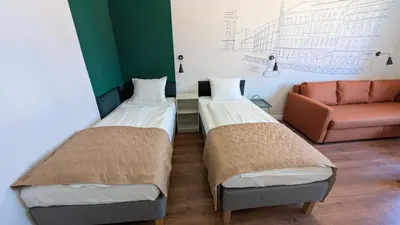 a room with two beds and a couch at Flat in Zizkov -502- in Prague