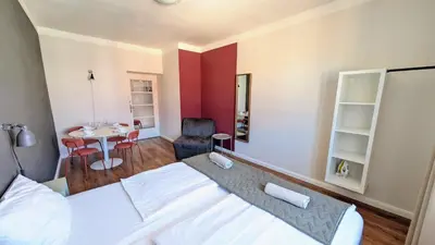 a bedroom with a bed and a table and a chair at Flat in Zizkov -502- in Prague
