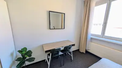 a room with a table and two stools and a mirror at Flat in Prague -503- in Prague