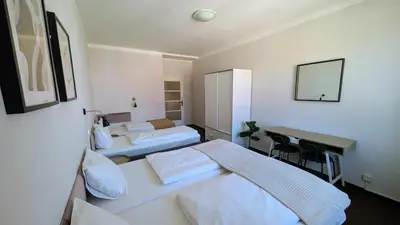 a hotel room with two beds and a desk at Flat in Prague -503- in Prague