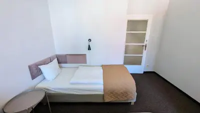 a small bedroom with a bed and a lamp at Flat in Prague -503- in Prague
