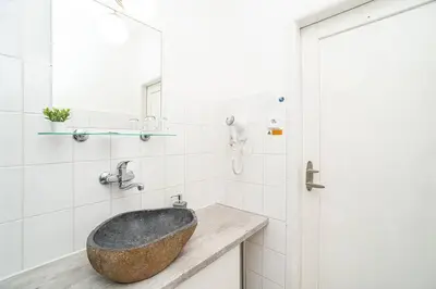 a bathroom with a stone sink on a counter at Modern studio with balcony + TV in Prague