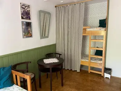 a room with a table and chairs and a bedroom at Ubytování u babičky in Peruc