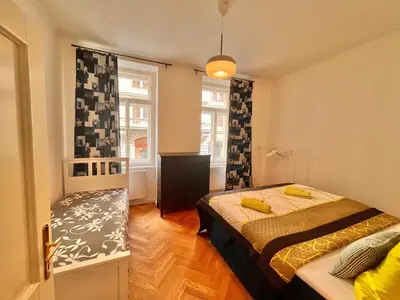 a small bedroom with a bed and a window at Amazing Apartment Zborovska in Prague