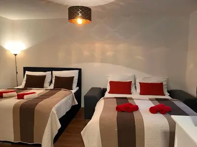 two beds in a room with red pillows on them at Amazing Apartment Zborovska in Prague