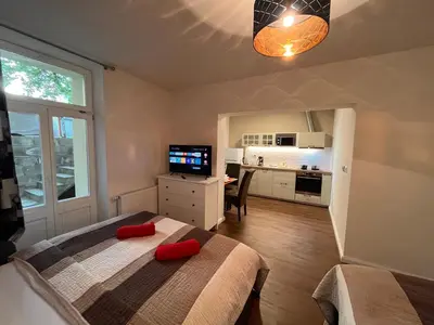 a bedroom with a bed with red pillows on it at Amazing Apartment Zborovska in Prague