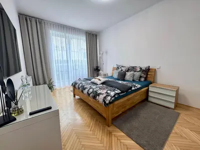 a bedroom with a bed and a large window at Apartmán Dlouhá 207 in Litoměřice