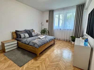 a bedroom with a bed and a large window at Apartmán Dlouhá 207 in Litoměřice