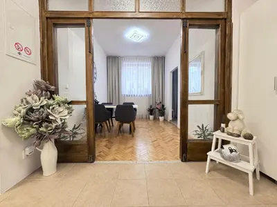 a living room with a large mirror and a dining room at Apartmán Dlouhá 207 in Litoměřice