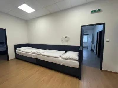 a large bed in a room with a mirror at Powder Tower Suites in Prague