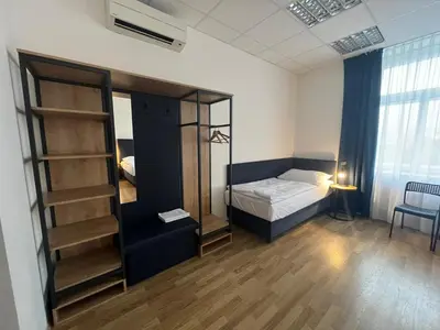 a bedroom with a bed and a book shelf at Powder Tower Suites in Prague