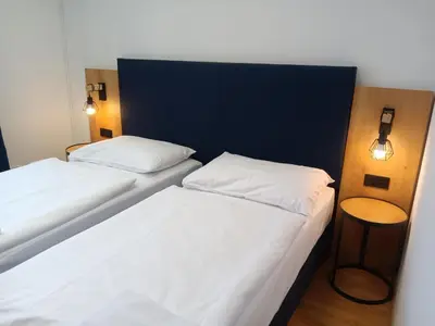 two beds in a room with lights on the wall at Powder Tower Suites in Prague