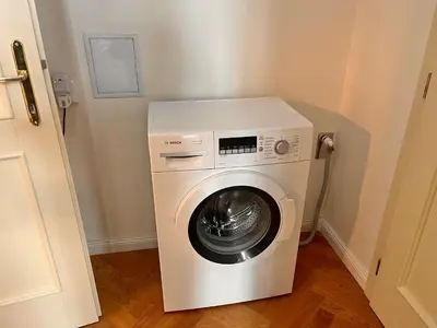 a washer and dryer in a small room at Cute Apartment Zborovska in Prague