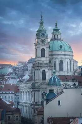 a large building with a clock tower in a city at Capitol deLuxe apartment in Prague