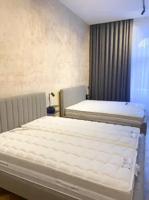 a bedroom with two beds and a window at Capitol deLuxe apartment in Prague