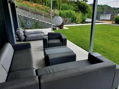 a patio with couches and chairs and a lawn at Pláž Hrdlička in Buš