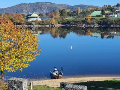 a boat sitting on the shore of a lake at Pláž Hrdlička in Buš