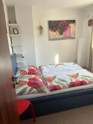 a bed in a room with a bedspread and pillows at Apartmán s wellness službami in Čerčany