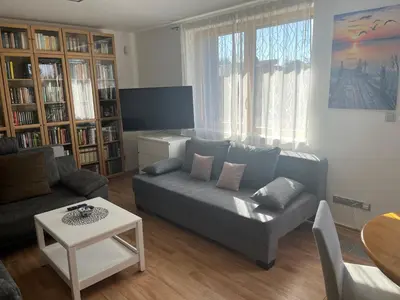 a living room with a couch and a table at Apartmán s wellness službami in Čerčany
