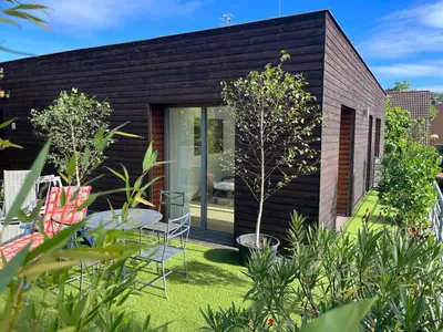 a house with a garden with a table and chairs at Apartmán s wellness službami in Čerčany
