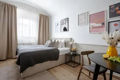 a bedroom with a bed and a table and a table sidx sidx sidx at TurnKey I Elegant Studio by National Museum in Prague