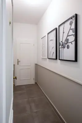 a hallway with three pictures on the wall at TurnKey I Elegant Studio by National Museum in Prague