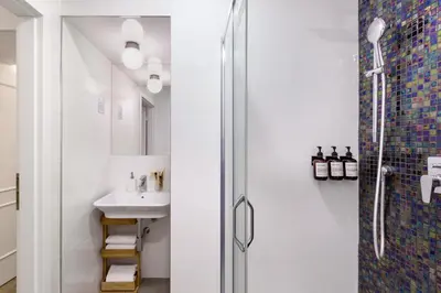 a bathroom with a shower and a sink at TurnKey I Elegant Studio by National Museum in Prague