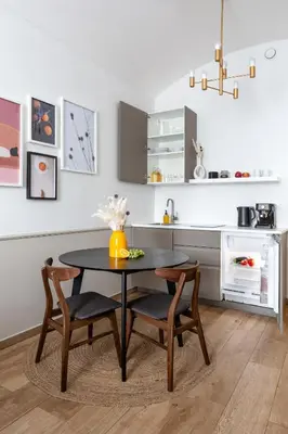 a kitchen with a table and chairs in a kitchen at TurnKey I Elegant Studio by National Museum in Prague