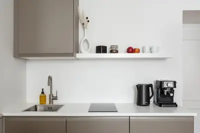 a kitchen with a sink and a counter top at TurnKey I Elegant Studio by National Museum in Prague