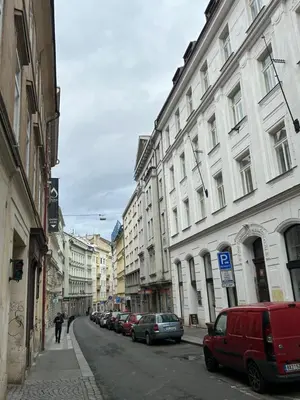 a city street with parked cars and buildings at PARTY HOUSE PRAGUE - Apartments Ve Smečkách 18, CITY CENTER!! in Prague